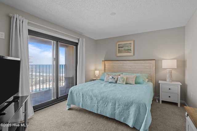 carpeted bedroom featuring access to outside, a textured ceiling, and a water view
