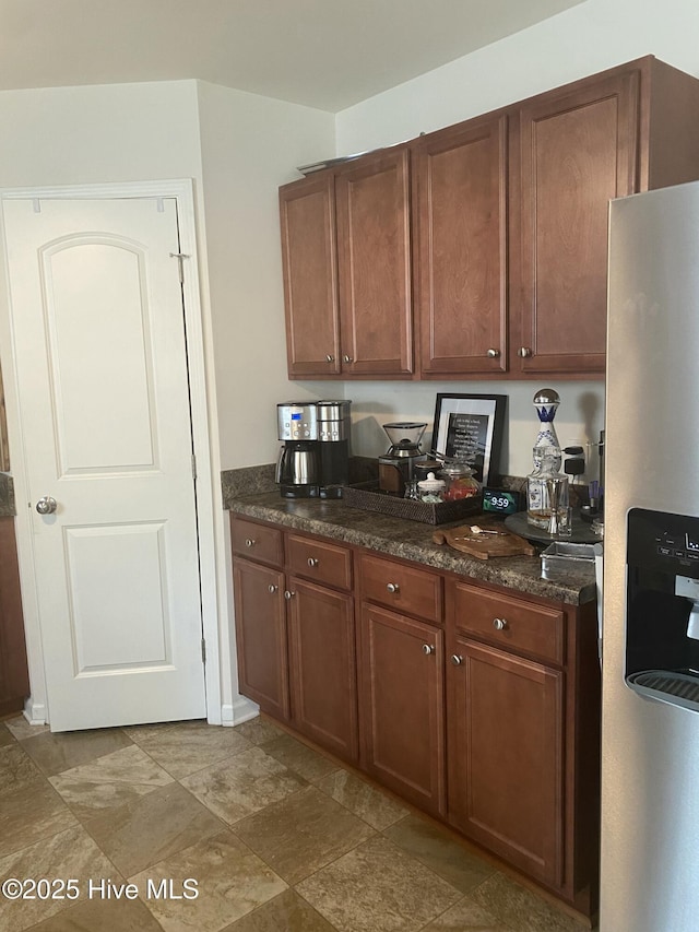 kitchen with brown cabinets and stainless steel fridge