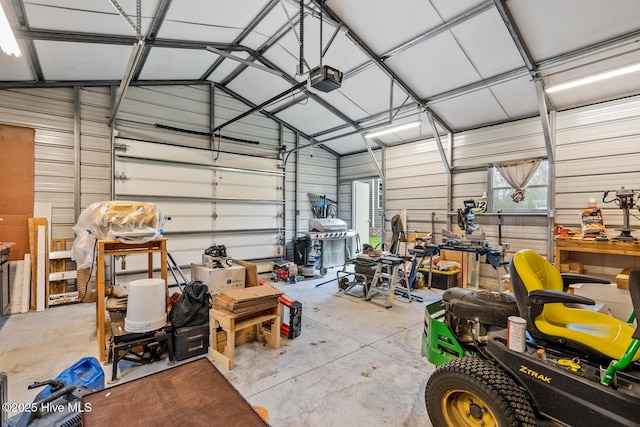 garage with metal wall and a garage door opener