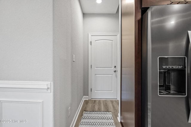 hallway with baseboards and wood finished floors