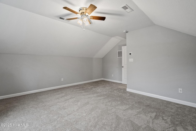 additional living space featuring lofted ceiling, visible vents, and baseboards