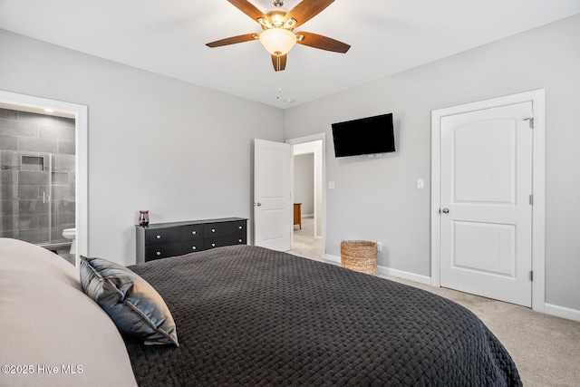 bedroom featuring ensuite bath, baseboards, a ceiling fan, and light colored carpet