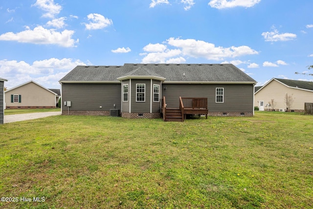 rear view of house featuring crawl space, central air condition unit, a deck, and a yard