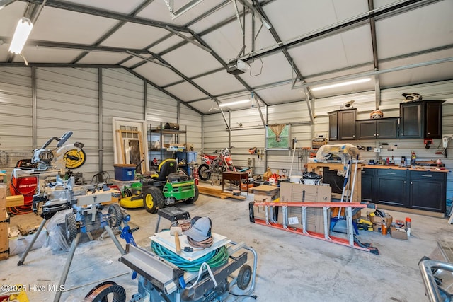 garage featuring metal wall and a garage door opener