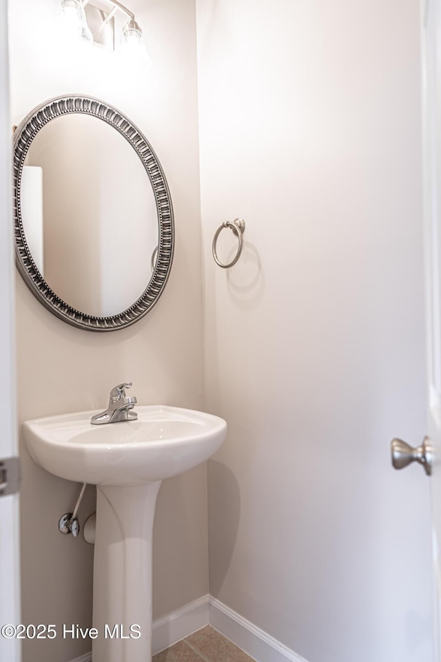 bathroom with baseboards and tile patterned flooring