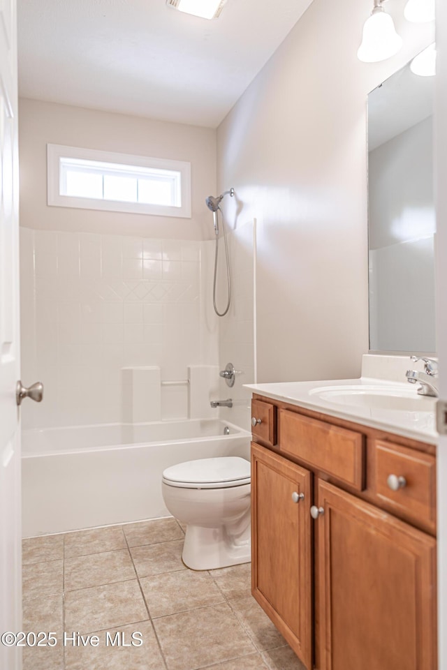 bathroom with vanity, tile patterned flooring, toilet, and shower / washtub combination