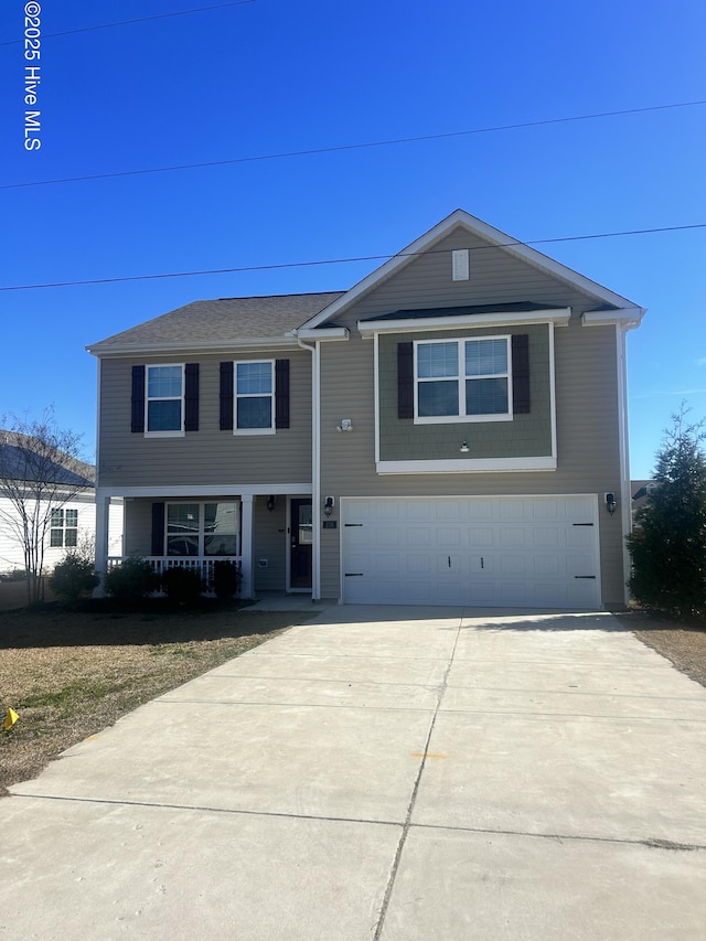 view of front of home with a garage, concrete driveway, and covered porch