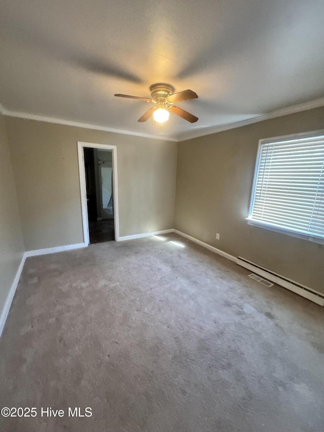 empty room with carpet, visible vents, ornamental molding, ceiling fan, and baseboards