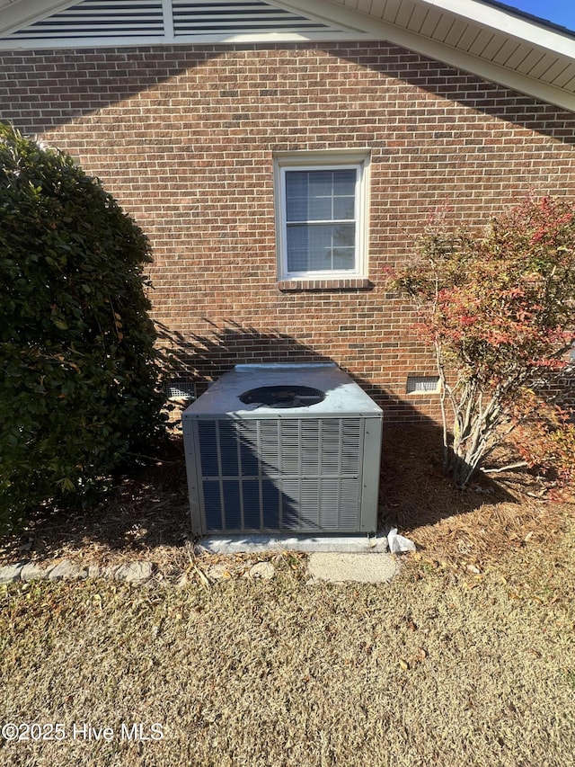 details with central AC, brick siding, and crawl space