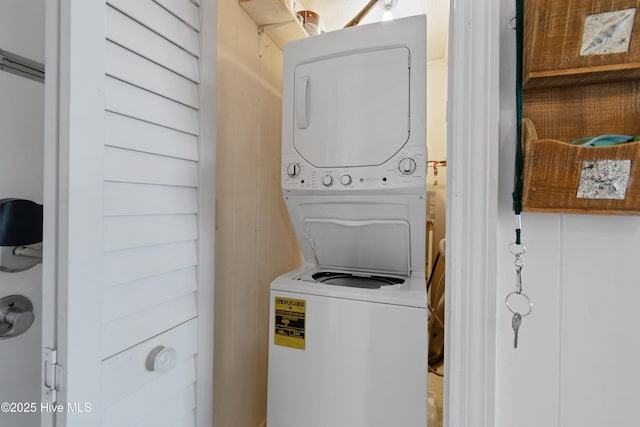 washroom with laundry area and stacked washer / drying machine