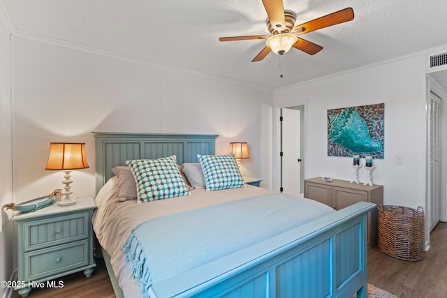 bedroom with ornamental molding, a ceiling fan, and dark wood-style flooring