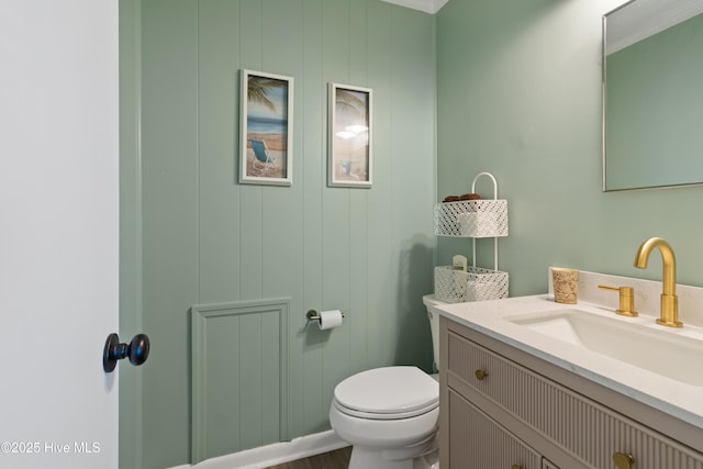 bathroom featuring vanity, toilet, and wood finished floors