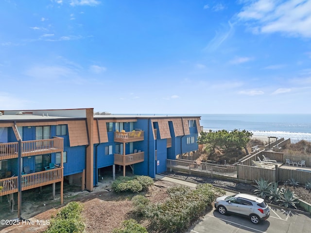 view of property featuring uncovered parking and a water view