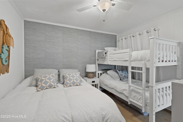 bedroom with a ceiling fan, a textured ceiling, and ornamental molding