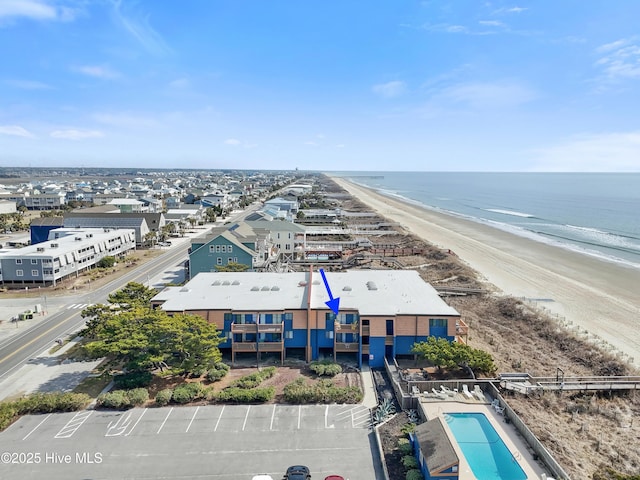 birds eye view of property with a view of the beach and a water view