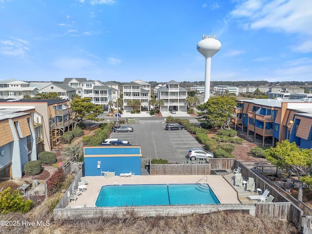 community pool with fence and a residential view