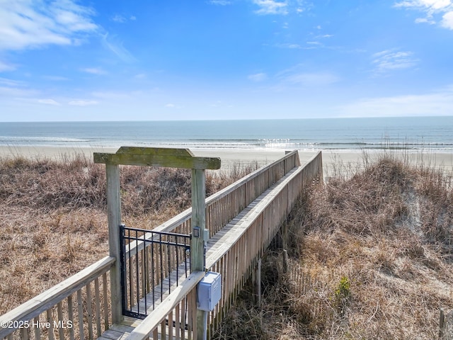 view of home's community featuring a beach view and a water view