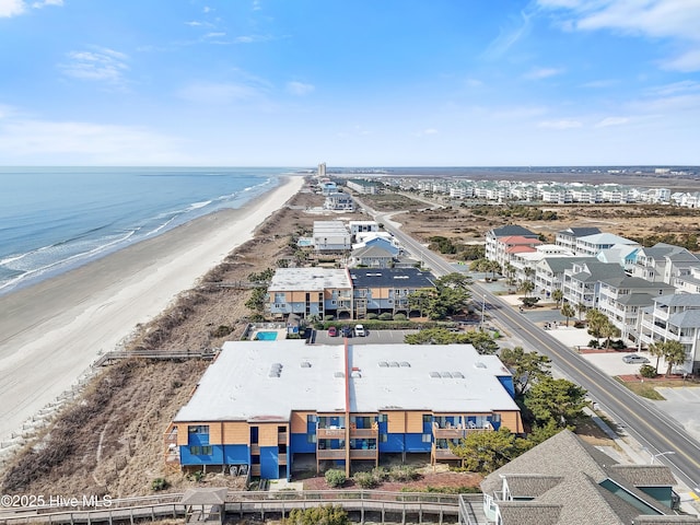 birds eye view of property featuring a beach view and a water view