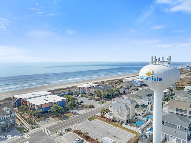 aerial view with a water view and a beach view