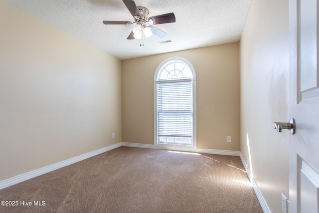 unfurnished room with baseboards, visible vents, ceiling fan, a textured ceiling, and carpet floors