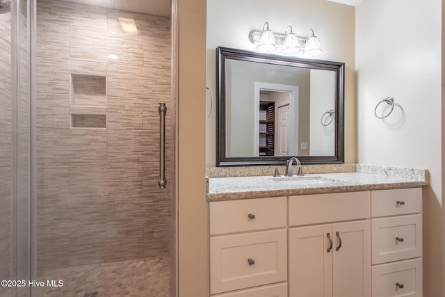 bathroom with a stall shower and vanity