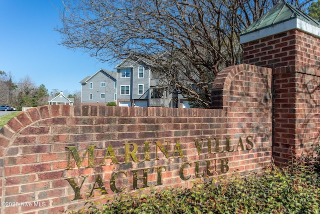 community / neighborhood sign with fence