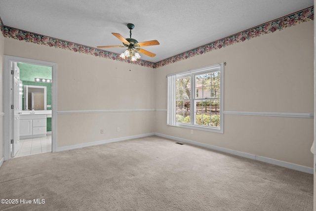 10 Lodge Pole Ln, Pinehurst, NC 28374 - carpeted spare room featuring ceiling fan, a textured ceiling, and baseboards