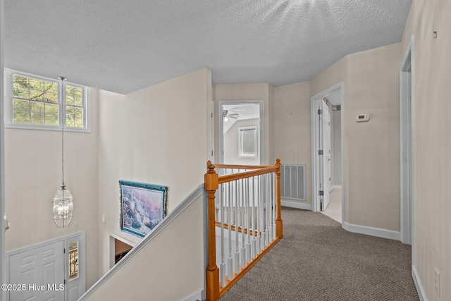 10 Lodge Pole Ln, Pinehurst, NC 28374 - hallway with an upstairs landing, a textured ceiling, carpet, and baseboards