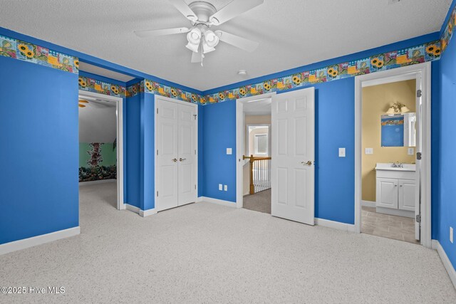 10 Lodge Pole Ln, Pinehurst, NC 28374 - unfurnished bedroom with carpet floors, a textured ceiling, baseboards, a sink, and a ceiling fan