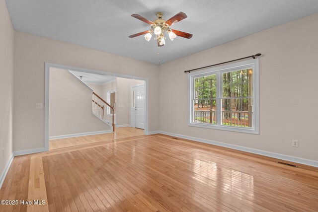 10 Lodge Pole Ln, Pinehurst, NC 28374 - spare room featuring a ceiling fan, light wood-style floors, stairway, and baseboards