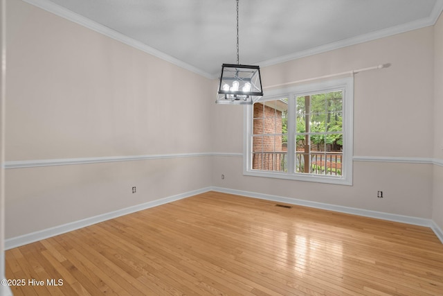 10 Lodge Pole Ln, Pinehurst, NC 28374 - unfurnished room with a chandelier, hardwood / wood-style floors, baseboards, and ornamental molding