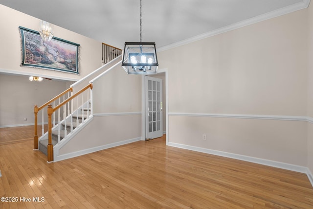 10 Lodge Pole Ln, Pinehurst, NC 28374 - stairway featuring a chandelier, hardwood / wood-style flooring, crown molding, and baseboards