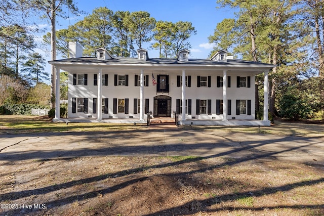 neoclassical / greek revival house featuring covered porch