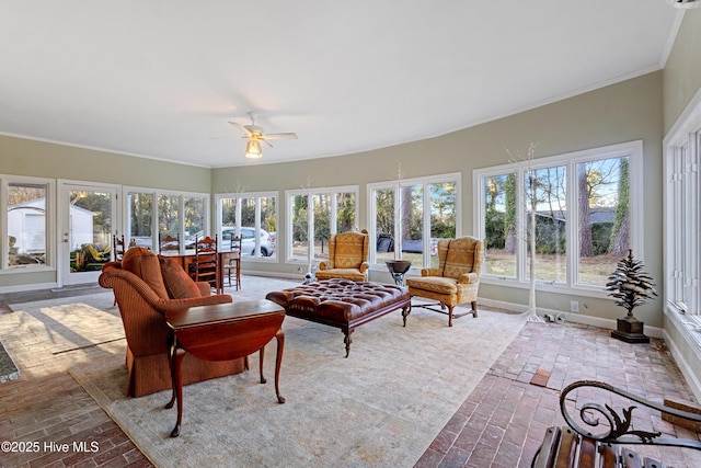 sunroom / solarium featuring ceiling fan