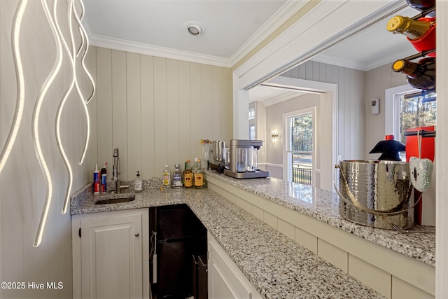 bar with ornamental molding, a sink, and wet bar