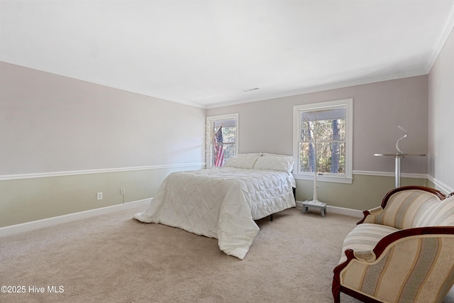 bedroom featuring baseboards, crown molding, and light colored carpet