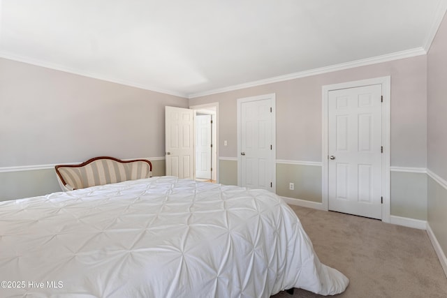 bedroom with carpet floors, ornamental molding, and baseboards