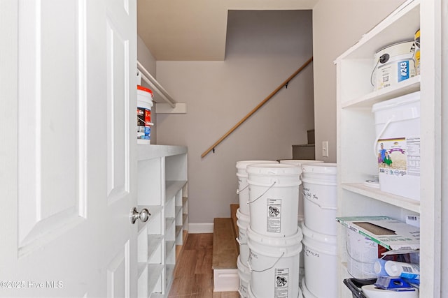 clothes washing area with wood finished floors