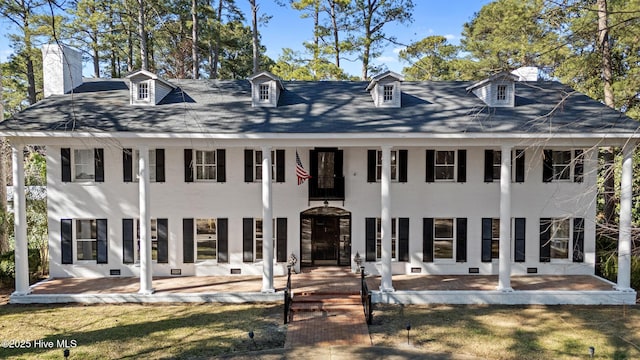 view of front facade with crawl space, a balcony, a front lawn, and a patio