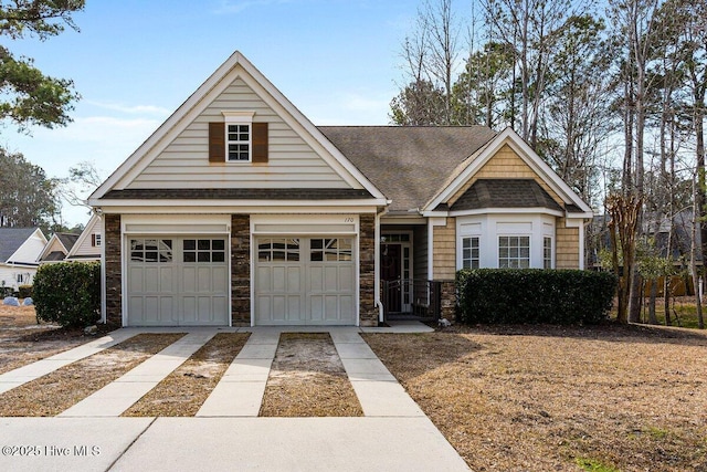 view of front of home with stone siding and driveway