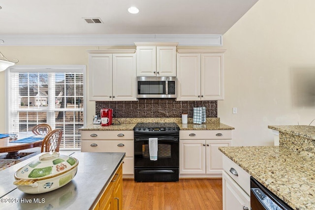 kitchen featuring light wood finished floors, tasteful backsplash, visible vents, ornamental molding, and black appliances