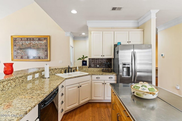 kitchen featuring stainless steel refrigerator with ice dispenser, visible vents, ornamental molding, a sink, and dishwasher