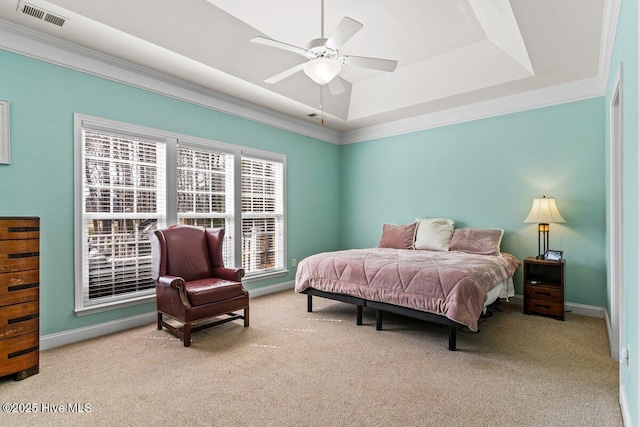 carpeted bedroom featuring ornamental molding, a tray ceiling, visible vents, and baseboards