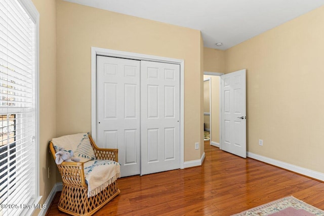 sitting room with wood finished floors and baseboards