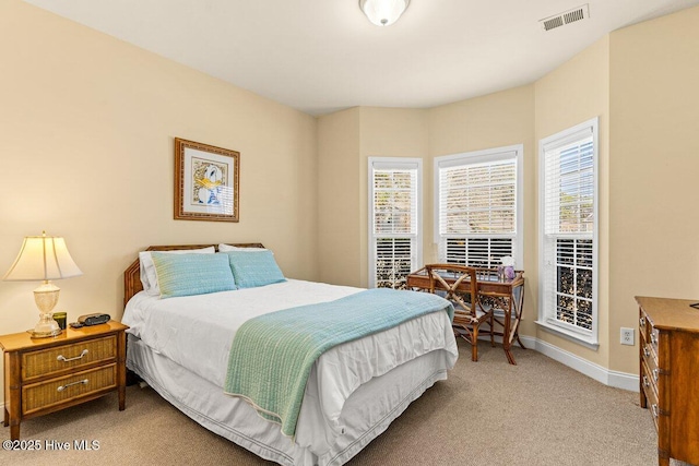 bedroom with light colored carpet, visible vents, and baseboards