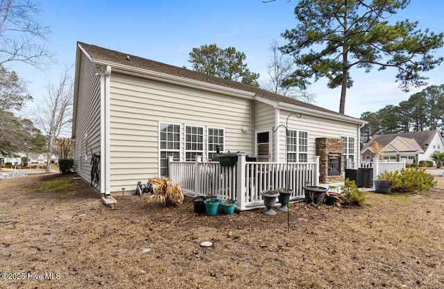 back of house featuring a wooden deck