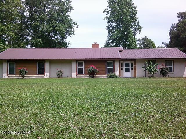 5200 Pineview Rd, Lumberton, NC 28360 - ranch-style home featuring stucco siding, a chimney, metal roof, and a front yard
