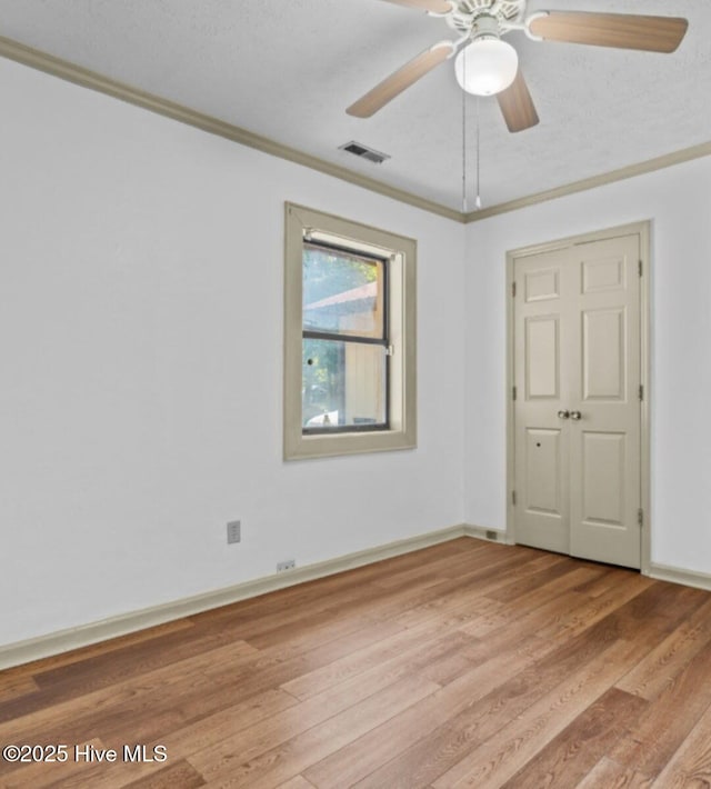 5200 Pineview Rd, Lumberton, NC 28360 - spare room with ornamental molding, light wood-type flooring, ceiling fan, and baseboards