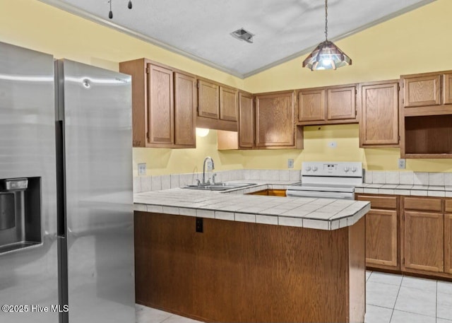 5200 Pineview Rd, Lumberton, NC 28360 - kitchen featuring stainless steel fridge, white electric range, lofted ceiling, a sink, and tile countertops