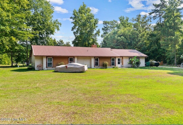 5200 Pineview Rd, Lumberton, NC 28360 - ranch-style home with stucco siding, a chimney, a front yard, and metal roof